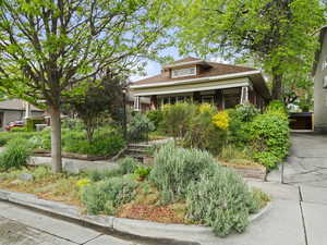 Bungalow-style house with brick siding and roof with shingles
