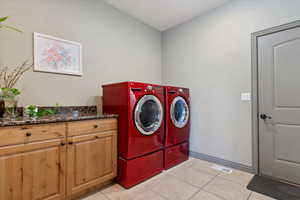 Laundry room with plenty of storage and counter space for folding.