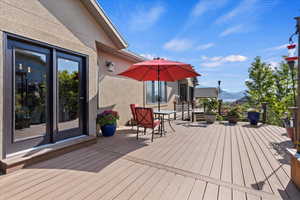Wooden terrace featuring a mountain view