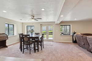 Dining space with a ceiling fan with french doors that walkout to backyard.