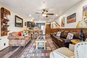 Living room with recessed lighting, ceiling fan, and dark wood-type flooring