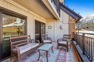 Balcony featuring a mountain view and an outdoor living space