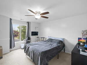 Carpeted bedroom with a textured ceiling, ceiling fan, visible vents, and baseboards