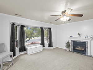 Unfurnished room with carpet flooring, ceiling fan, and crown molding