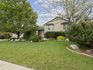 Tri-level home featuring brick siding and a front lawn