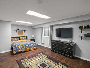 Bedroom with baseboards and wood finished floors