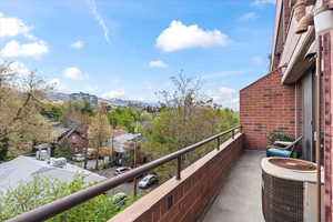 Balcony featuring central AC and a mountain view