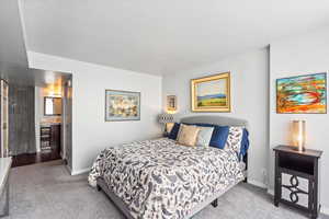 Bedroom featuring carpet floors and baseboards