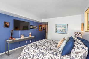 Bedroom featuring carpet floors and baseboards
