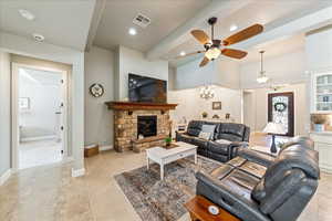 Living room with ceiling fan, visible vents, a fireplace, light carpet, and recessed lighting