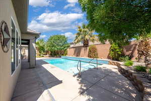 View of swimming pool featuring a fenced in pool, a fenced backyard, and a patio area