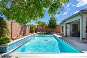 View of swimming pool with a fenced backyard, grilling area, a fenced in pool, and a patio area