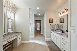Bathroom with visible vents, recessed lighting, baseboards, and vanity