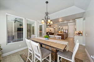 Dining space featuring baseboards, recessed lighting, light tile patterned flooring, and a notable chandelier