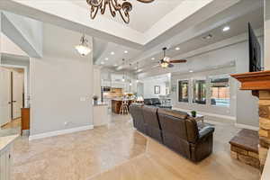 Living room featuring visible vents, recessed lighting, baseboards, and ceiling fan with notable chandelier