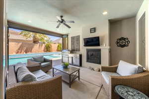 View of patio with ceiling fan, grilling area, a fenced backyard, an outdoor hangout area, and a fenced in pool