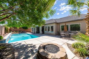 View of swimming pool featuring a fenced in pool, a fenced backyard, a patio area, and a fire pit
