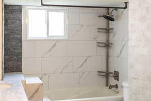 Full bath featuring toilet and  shower combination