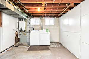 Clothes washing area with tankless water heater, laundry area, and washing machine and clothes dryer