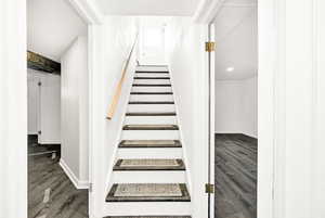 Staircase with baseboards and wood finished floors