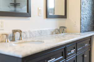 Full bathroom with double vanity and a sink