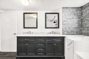 Bathroom featuring a sink and double vanity