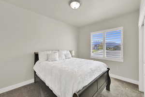 Carpeted bedroom featuring baseboards