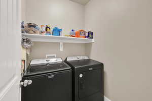 Laundry area featuring independent washer and dryer and laundry area