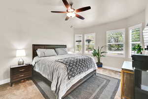 Carpeted bedroom with baseboards and ceiling fan