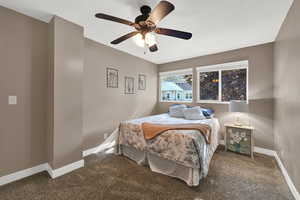 Bedroom featuring carpet floors, baseboards, and ceiling fan