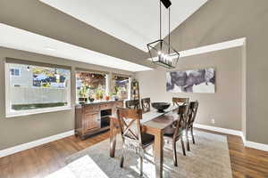 Dining area featuring an inviting chandelier, recessed lighting, baseboards, wood finished floors, and visible vents