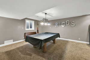 Recreation room featuring baseboards, carpet floors, and visible vents