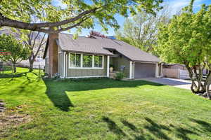 Single story home with fence, a shingled roof, board and batten siding, concrete driveway, and an attached garage