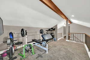 Workout room with baseboards, carpet, and lofted ceiling