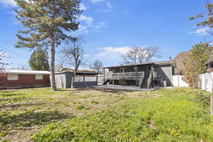 Rear view of house with central AC, a yard, a fenced backyard, stairway, and a deck