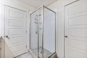 Bathroom with a stall shower, vanity, and a textured ceiling