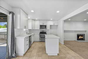 Kitchen featuring recessed lighting, light countertops, appliances with stainless steel finishes, and backsplash