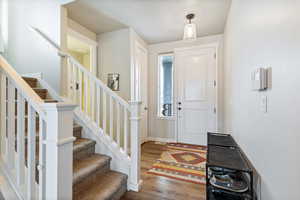 Entryway featuring stairs and wood finished floors
