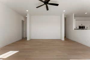 Unfurnished living room with recessed lighting, baseboards, ceiling fan, and light wood-style floors