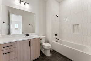 Bathroom with toilet, shower / washtub combination, and vanity
