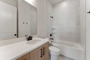Full bath with vanity,  shower combination, and toilet