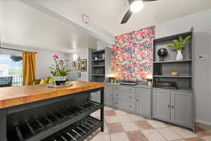 Kitchen with open shelves, ceiling fan, light tile patterned flooring, and gray cabinetry