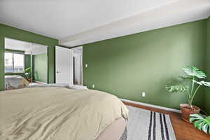 Bedroom featuring baseboards and wood finished floors