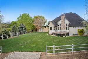 View of yard featuring a fenced backyard, a wooden deck, an outdoor structure, and a storage shed