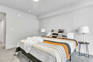 Carpeted bedroom with baseboards