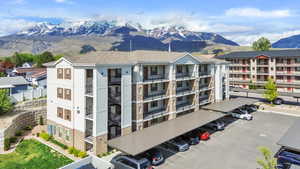 View of building exterior with uncovered parking and a mountain view
