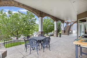 View of patio / terrace featuring stairway and outdoor dining space