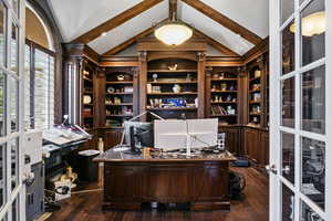 Office area with french doors, lofted ceiling with beams, dark wood-style flooring, and built in study area