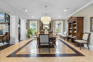 Dining area featuring an inviting chandelier, baseboards, decorative columns, and recessed lighting