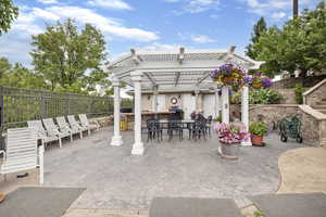 View of patio / terrace with a fenced backyard, outdoor dry bar, a pergola, and area for grilling
